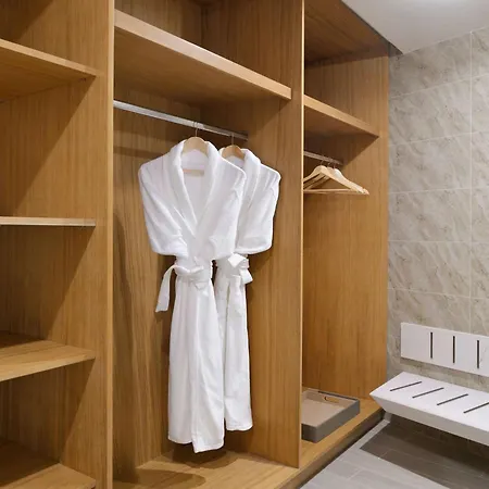 Moevenpick Hotel & Apartments Ghala Muscat Exterior photo A bathrobe hanging in a closet